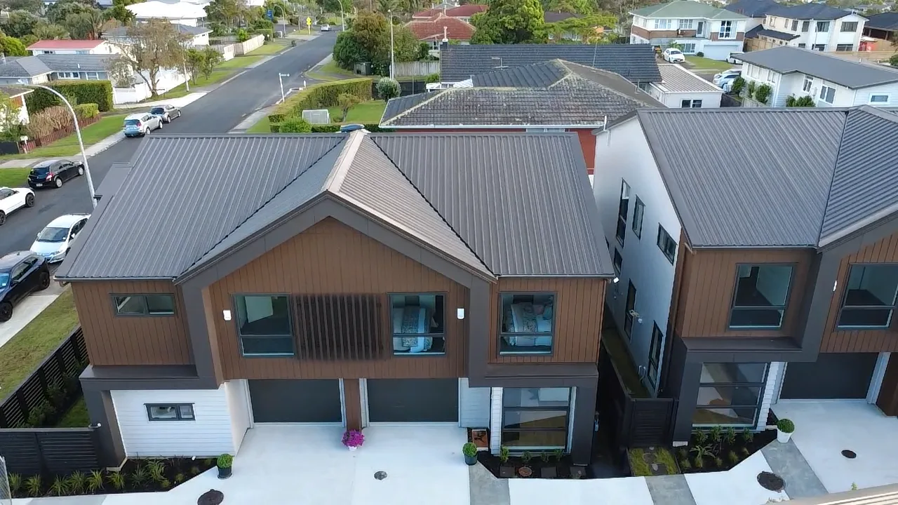 Drone view of modern dark-clad Auckland houses